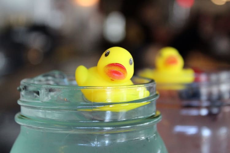 a rubber ducky floating in a drink