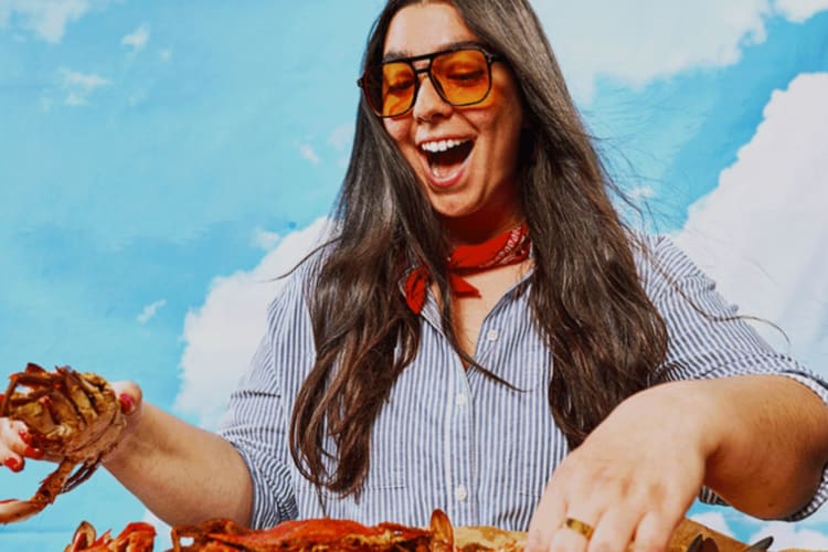 a woman happily examining fresh crabs