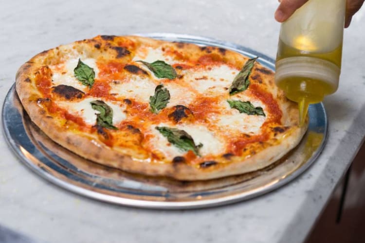 Pizza making classes are a great idea for National Cheese Pizza Day. 