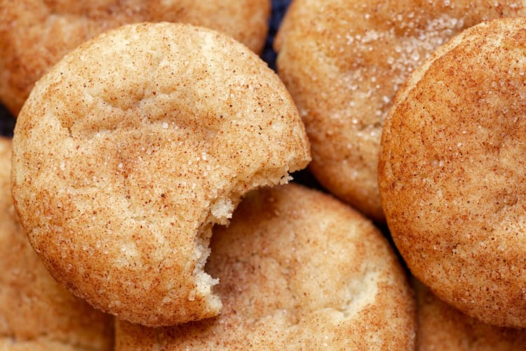 Snickerdoodle cookies, one with a bite missing