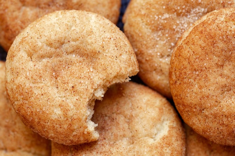 snickerdoodle cookies, one with a bite missing