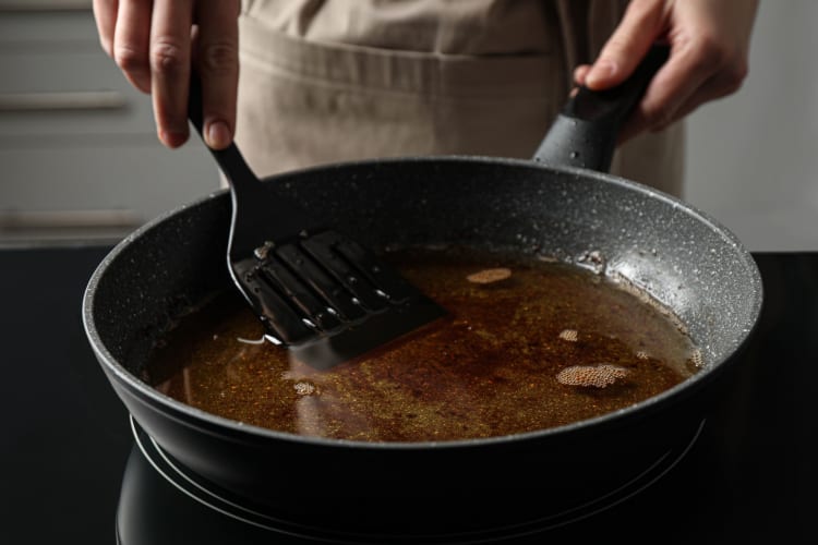 chef putting spatula in hot oil