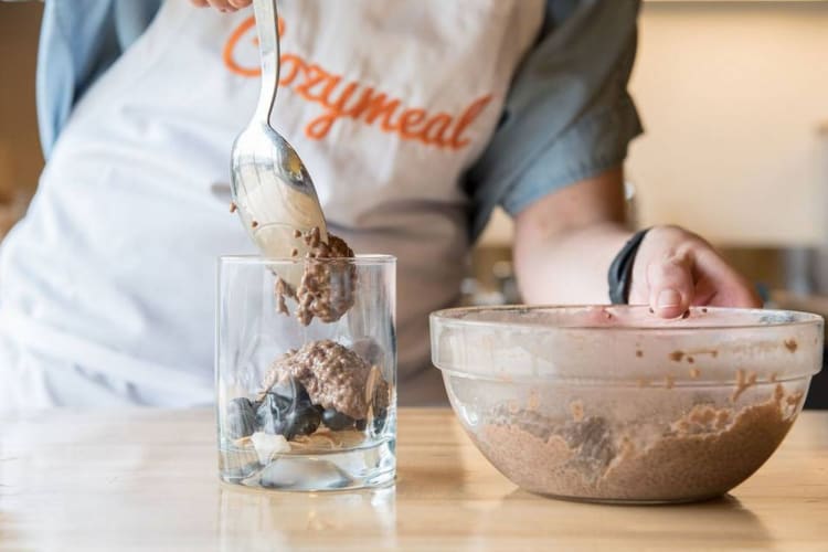 chef spooning out chocolaty mixture into cup