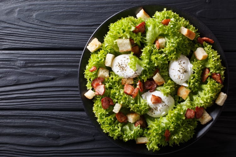 salad Lyonnaise on a dark background