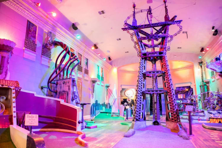 a colorful, vibrant room for playing mini-golf