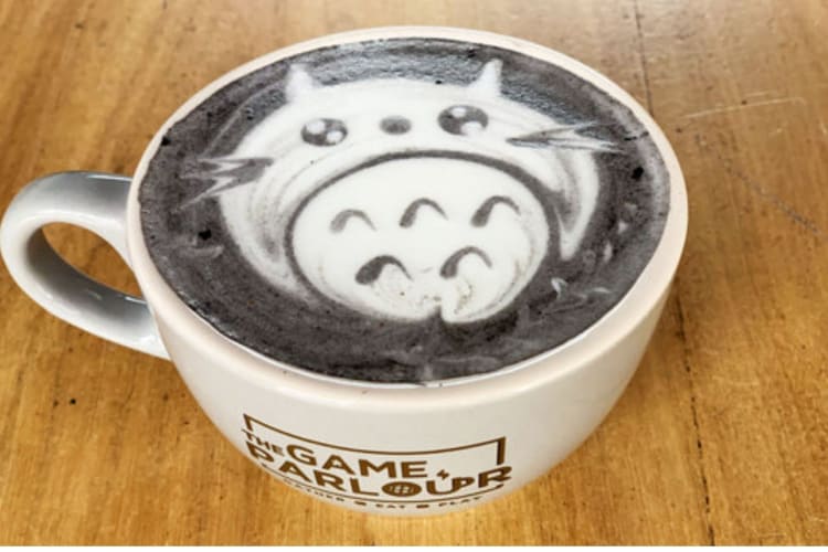 cup of coffee with a cat design in the foam