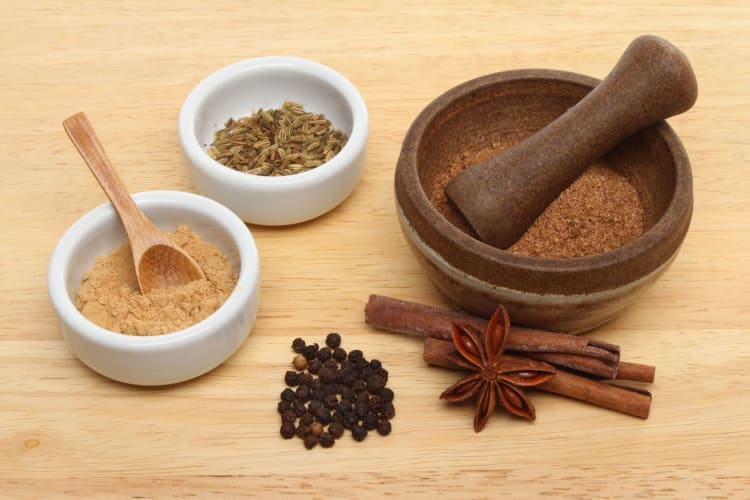 ingredients for Chinese five spice blend with mortar and pestle
