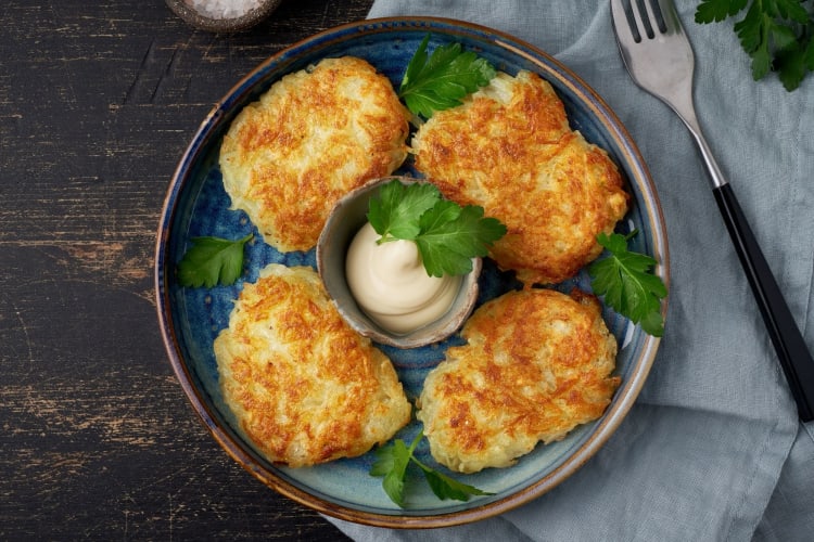 hash browns on a round plate with sauce in the center