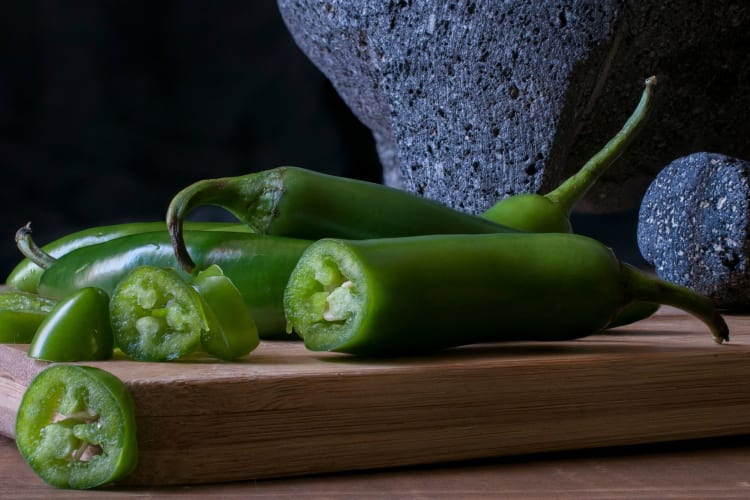 serrano peppers close up, some sliced