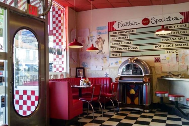 '50s-style interior with jukebox, red vinyl booths and checkered floors