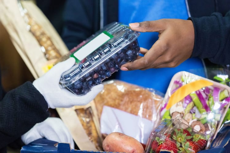 people organizing healthy produce at a food drive