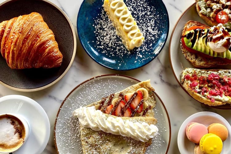 a delicious looking breakfast spread including croissants and macarons