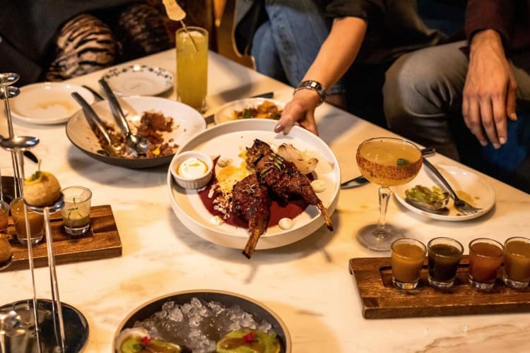 a table laden with Indian dishes and sauces