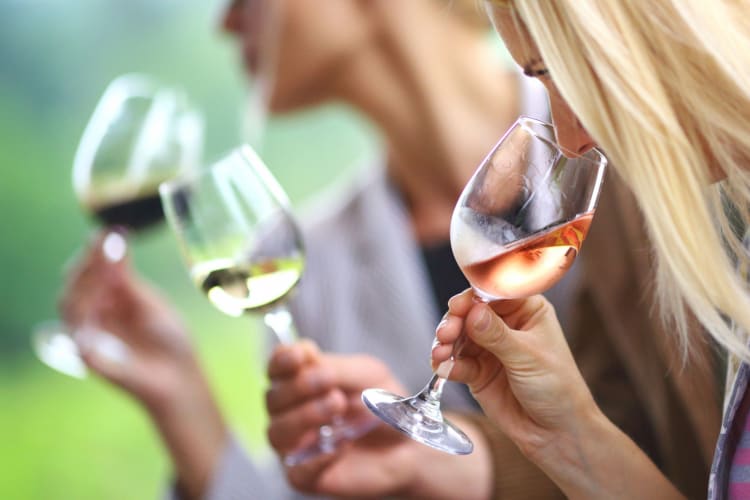 woman sniffing wine to catch aromas at a wine tasting