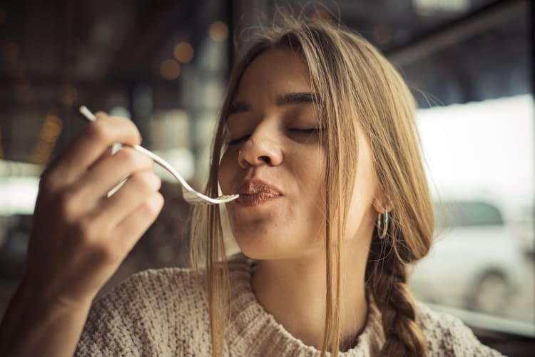 A woman enjoying a bite of food