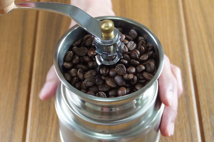 Grind fresh coffee beans for the best Americano.