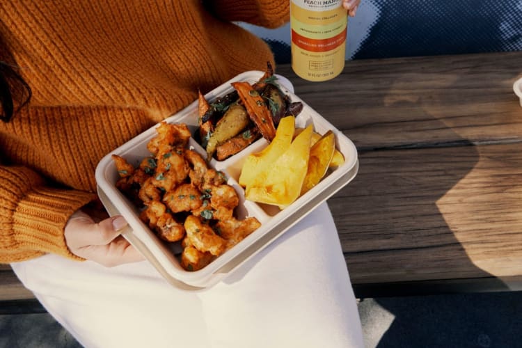 a woman having a hot bar lunch to-go