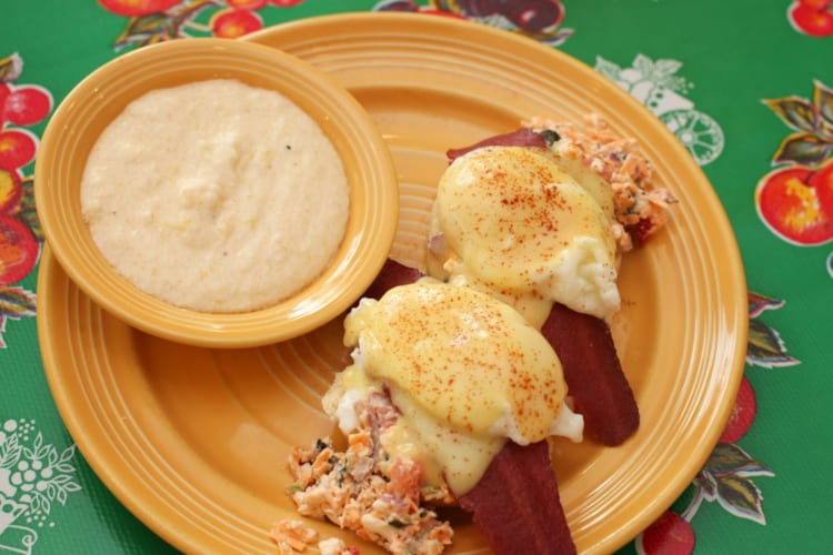 Benedict-style eggs with bacon and a side of grits