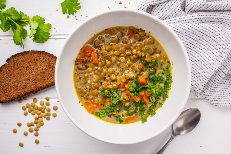 a dish of lentil curry garnished with cilantro