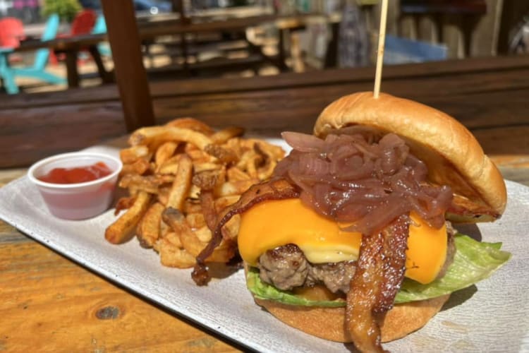 A cheeseburger with bacon and caramelized onions