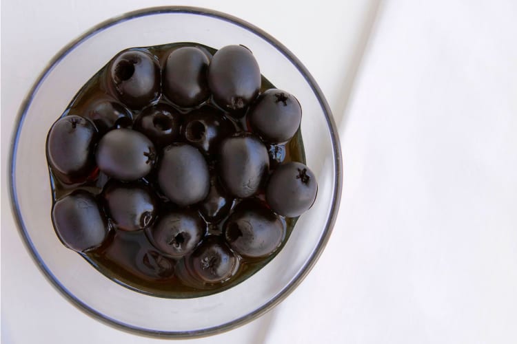 a bowl of pitted black olives