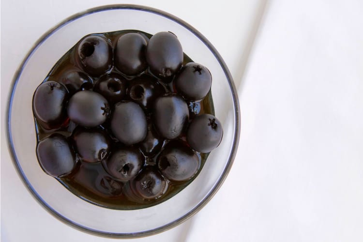 a bowl of pitted black olives