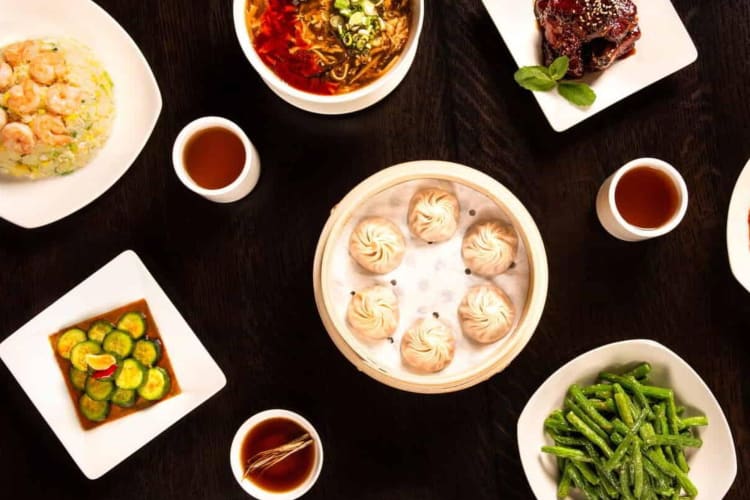 a spread of dumplings and other Chinese foods.