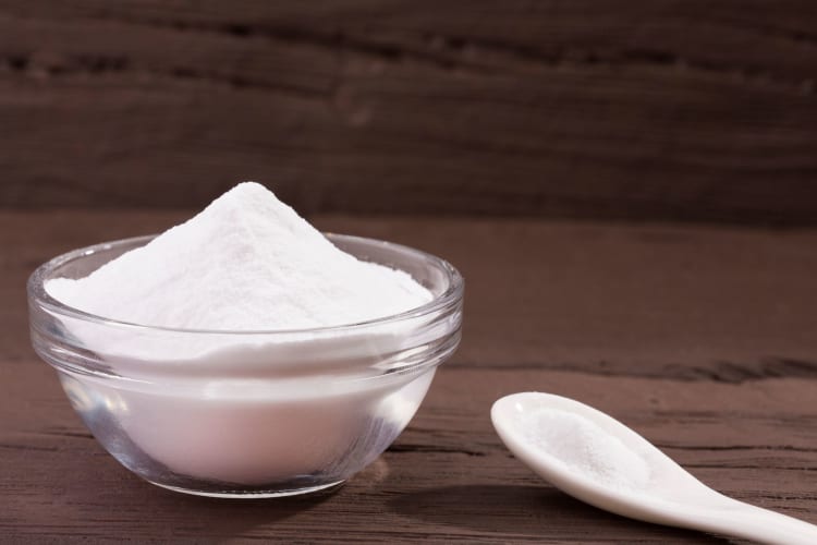 stevia in a bowl with a spoon beside it