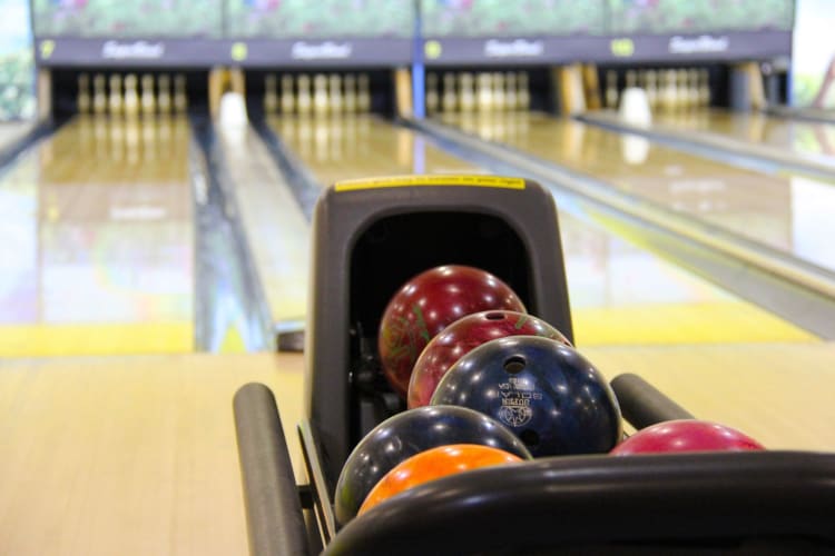 bowling balls and a lane at a bowling alley