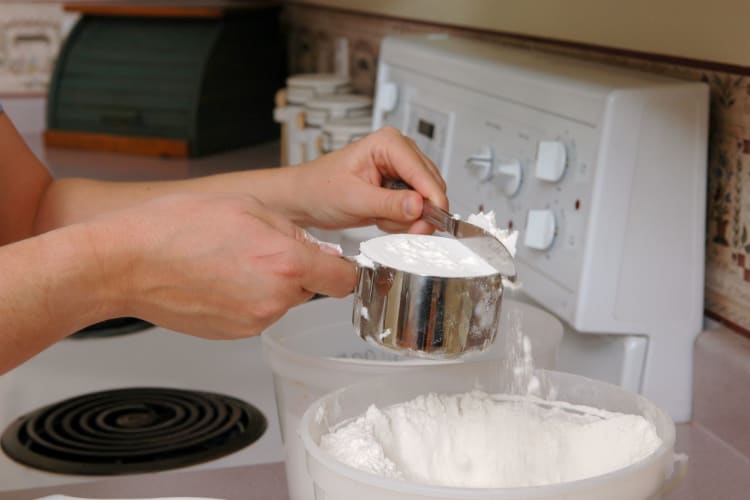 woman measuring flour for cooking