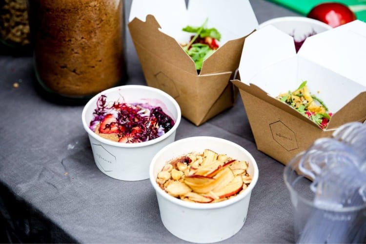 two bowls of porridge prepared for takeout