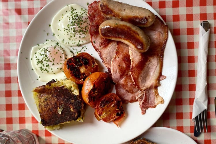 a large breakfast of eggs, sausages, tomatoes and other meats