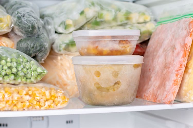 tupperware in freeze with a smiley face drawn on