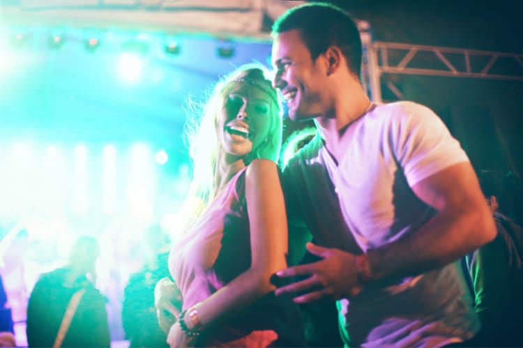 a man and woman dancing at a concert