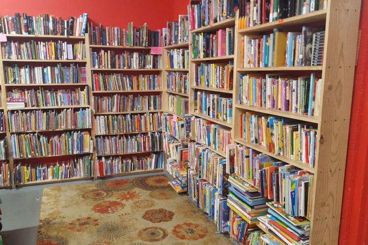 the fully packed shelves of The Book Thing