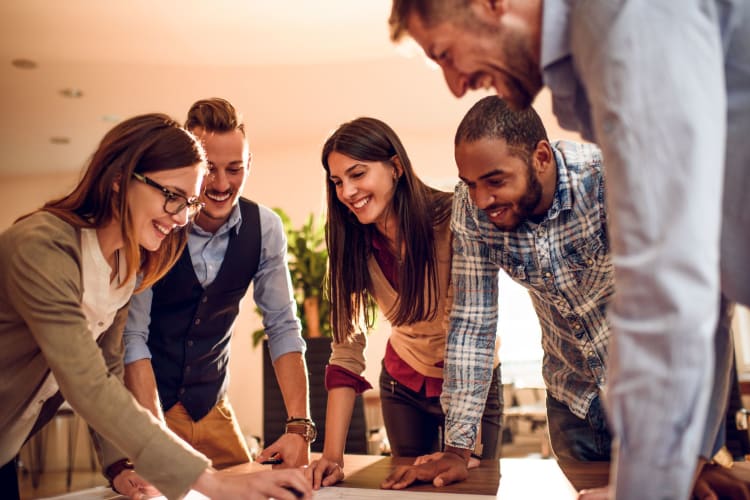 a group of people working together in an office