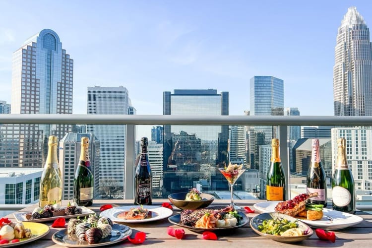 beautiful spread of food next to a high-up balcony