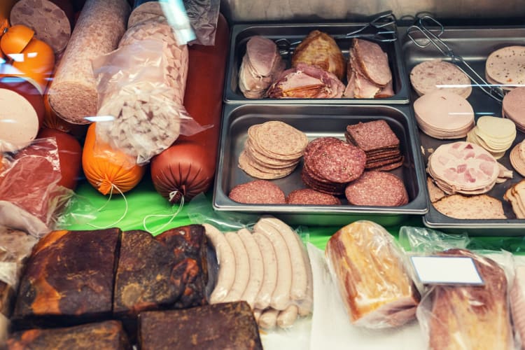 a variety of deli meats in a farmers market