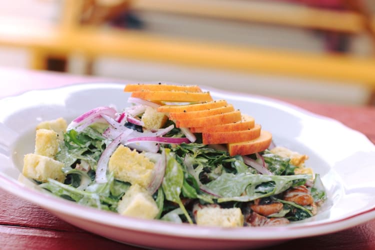 a fresh salad topped with fruit