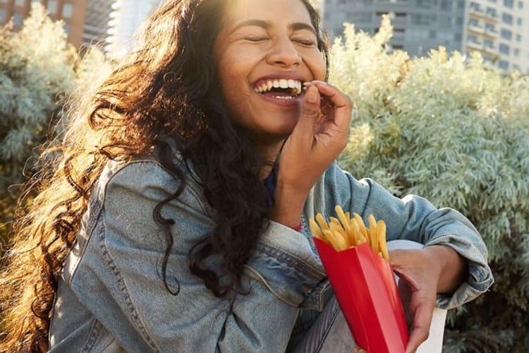 a girl eating fries