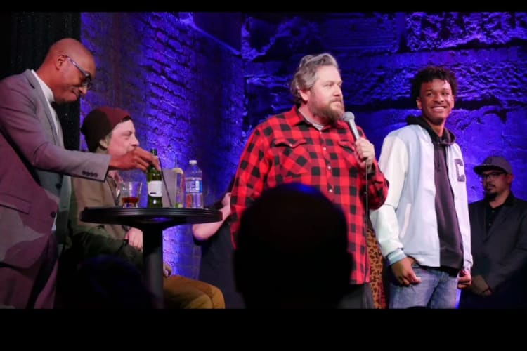 comedians on stage doing improv 