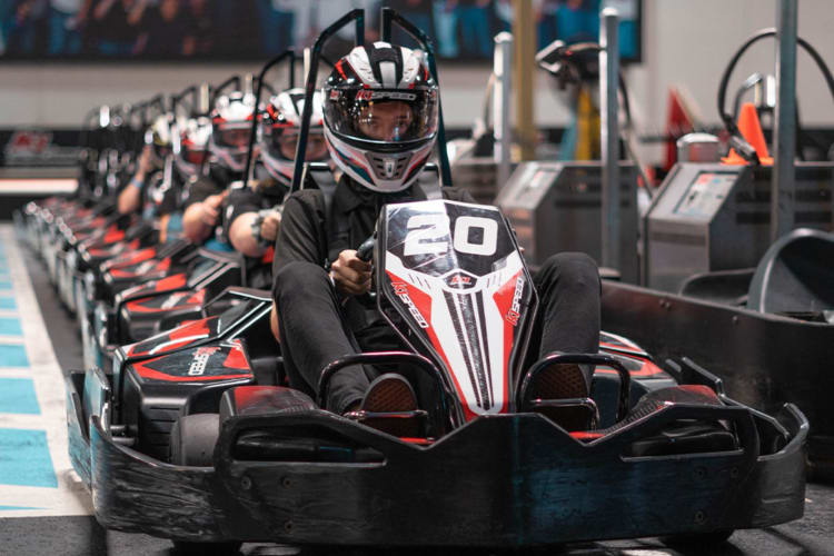 a line of people in go-karts waiting to take off.