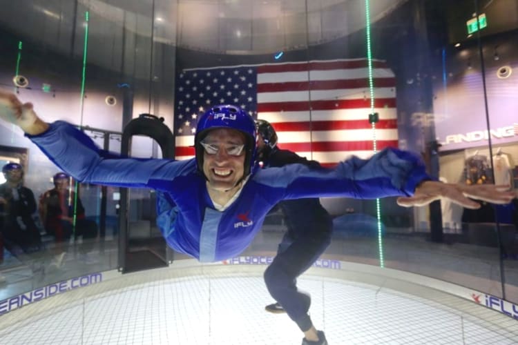 a man doing indoor skydiving