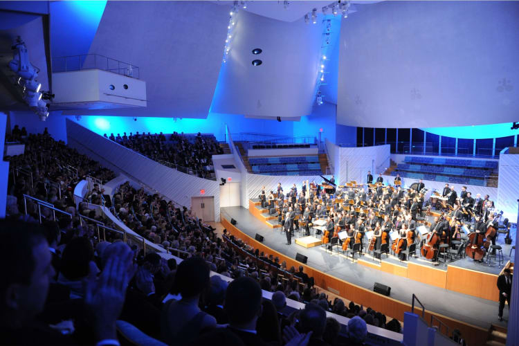 a symphony performing at the Kravis Center