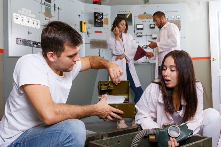 four people examining clues in an escape room