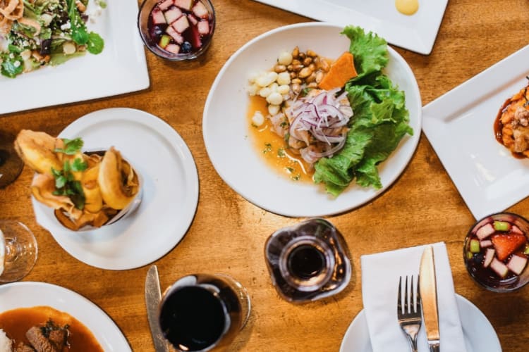 a spread of Peruvian dishes on a wooden table