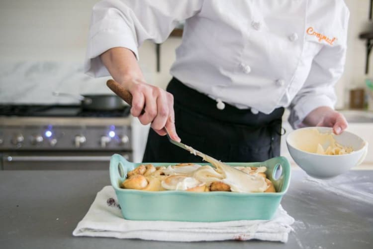 a chef icing cinnamon buns