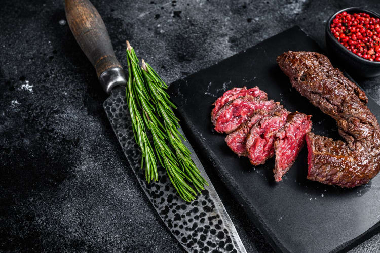 rare hanger steak on gray background