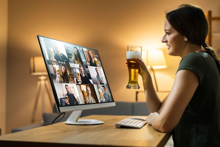 woman toasting during a virtual call