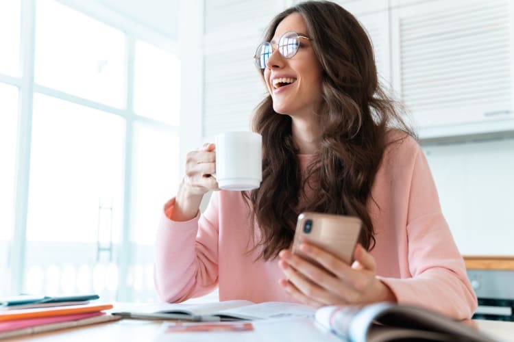 woman having coffee and chatting on phone